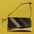 Black and Gold shoulder bag with musical bag charm.