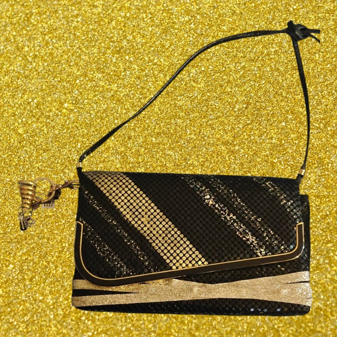 Black and Gold shoulder bag with musical bag charm.